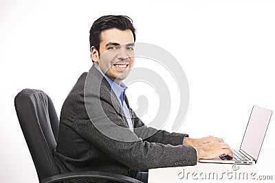 Happy young businessman working on laptop Stock Photo