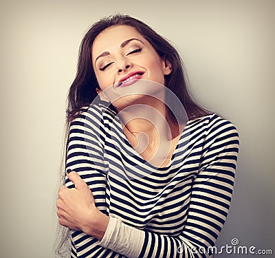 Happy young casual woman hugging herself with natural emotional Stock Photo