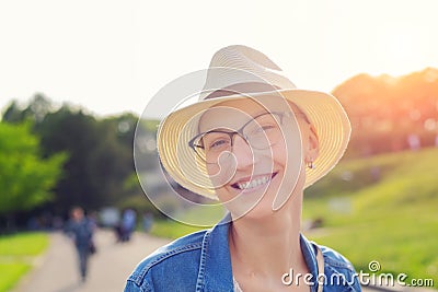 Happy young caucasian bald woman in hat and casual clothes enjoying life after surviving breast cancer. Portrait of beautiful Stock Photo