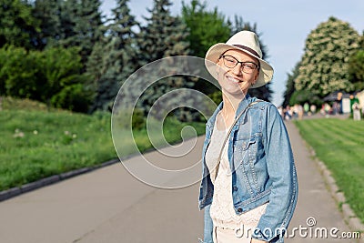 Happy young caucasian bald woman in hat and casual clothes enjoying life after surviving breast cancer. Portrait of Stock Photo