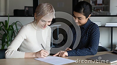 Happy multiracial businesswomen close deal at meeting Stock Photo