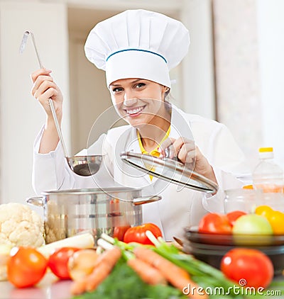 Happy young cook tests vegetarian food Stock Photo