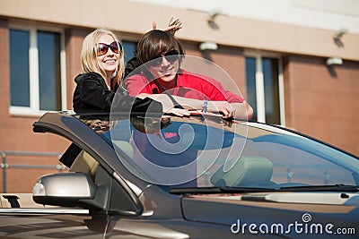 Happy young fashion couple in a car Stock Photo