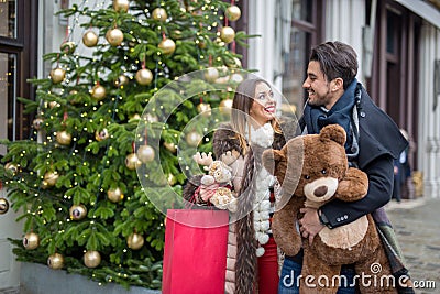 Happy young couple christmas shopping on the street Stock Photo