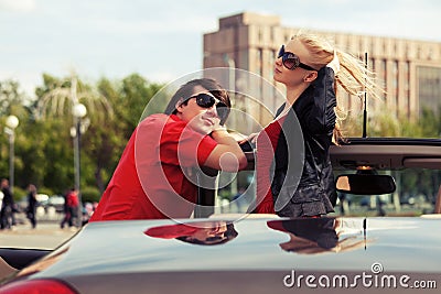 Happy young couple in convertible car Stock Photo