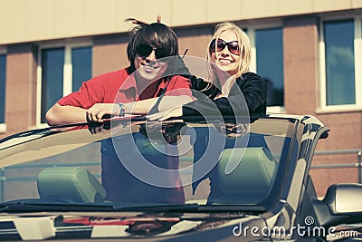 Happy young couple in convertible car Stock Photo