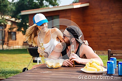 Happy young couple drinking beer outdoors together Stock Photo