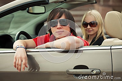 Happy young couple driving convertible car Stock Photo