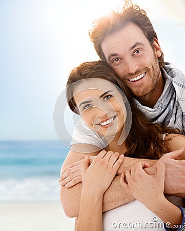Happy young couple embracing on summer beach Stock Photo