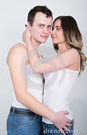 Happy young couple enjoying an intimate moment, laughing a lot and man gently strokes his partner's hair Stock Photo