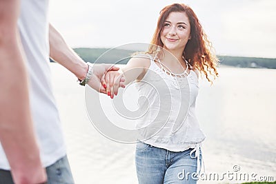 Happy young couple enjoying a solitary beach backriding Stock Photo