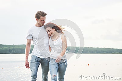 Happy young couple enjoying a solitary beach backriding Stock Photo