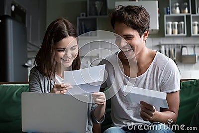 Happy young couple excited by reading good news in letter Stock Photo