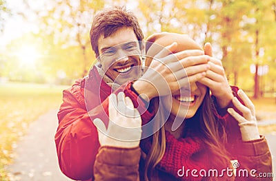 Happy young couple having fun in autumn park Stock Photo