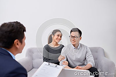 Happy young couple hold each otherÃ¢??s hands listening to female agent, planning wedding, consulting investment advisor, hearing Stock Photo