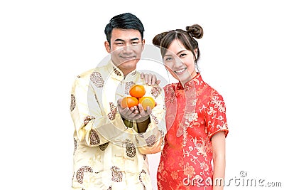 Happy Young couple holding orange. Chinese new year. Stock Photo