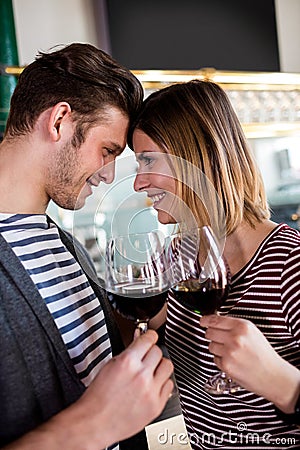 Happy young couple holding wineglass Stock Photo