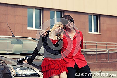 Happy young couple in love by convertible car Stock Photo