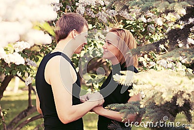 Happy young couple in love in a garden Stock Photo