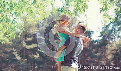 Happy young couple in love hugging enjoys spring day, loving man holding on hands his woman carefree together outdoors walking Stock Photo