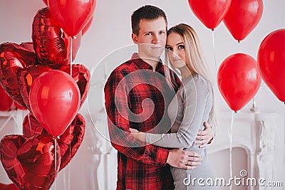 Happy young couple in love posing with red heart balloons Stock Photo