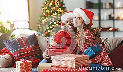 Happy couple opening presents on Christmas morning Stock Photo