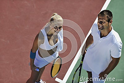 Happy young couple play tennis game outdoor Stock Photo