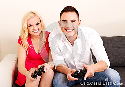 Happy young couple playing video games Stock Photo
