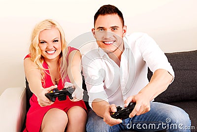 Happy young couple playing video games Stock Photo