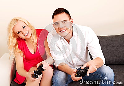 Happy young couple playing video games Stock Photo