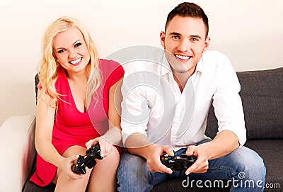 Happy young couple playing video games Stock Photo