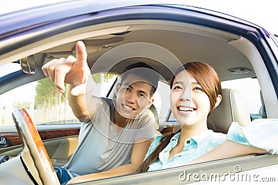 Happy Young Couple Sitting In the Car Stock Photo