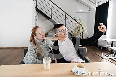 Happy young couple taking selfie with smart phone at cafe in mall. Copy space for your text Stock Photo