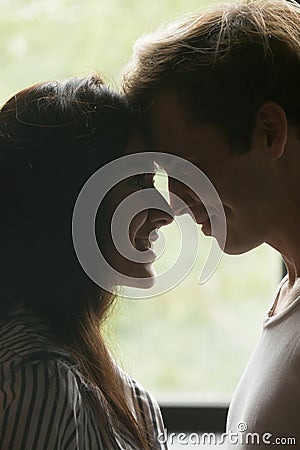 Happy young couple touching noses, looking in the eyes, closeup Stock Photo