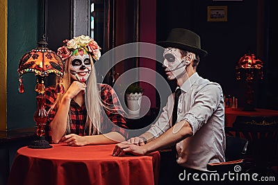 Young attractive couple with undead makeup during dating at a mexican restaurant. Stock Photo