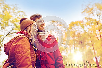 Happy young couple walking in autumn park Stock Photo