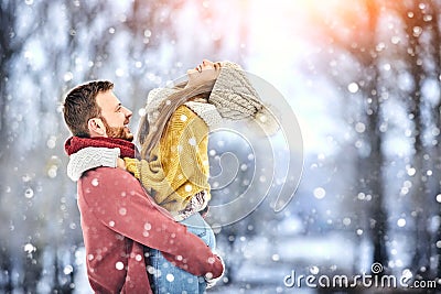 Happy Young Couple in Winter Park laughing and having fun. Family Outdoors. Stock Photo