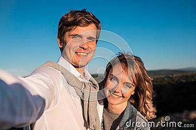 Happy young cute couple making selfie outdoors Stock Photo