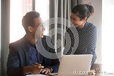 Happy young diverse employees discussing project agreement Stock Photo