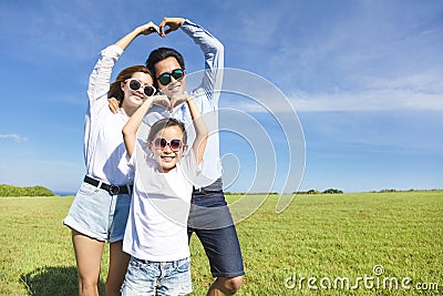 Happy young family forming love shape Stock Photo