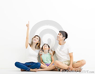 Happy Young Family pointing and looking up Stock Photo