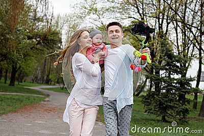 Happy young family taking video selfies with her camera on the gimbal steadycam Stock Photo