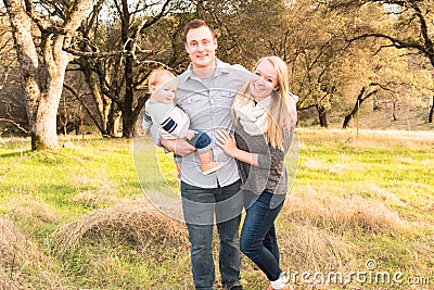 Happy Young Family Together Outdoors Stock Photo