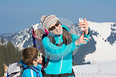 Happy young family in winter vacation smartphone selfie Stock Photo