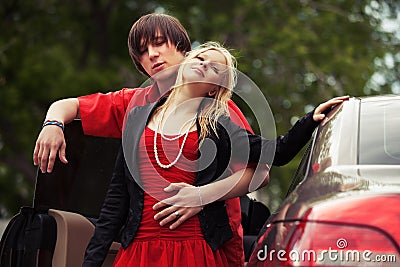 Happy young fashion couple in love by car Stock Photo