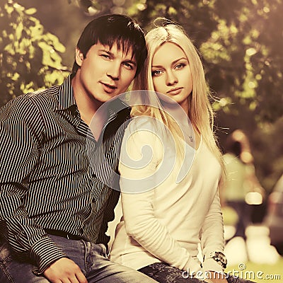 Happy young fashion couple in love in city park Stock Photo