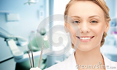 Happy young female dentist with tools Stock Photo