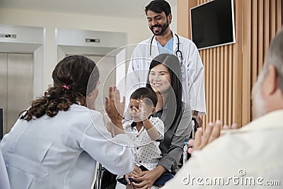 Female pediatric doctor teasing boy for examination at hospital. Stock Photo