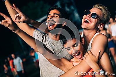 Happy friends having fun at music festival Stock Photo