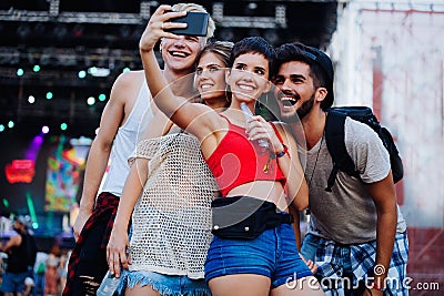 Happy friends taking selfie at music festival Stock Photo